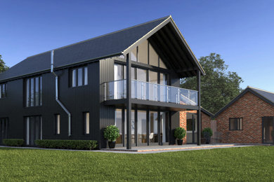 Photo of a large and black contemporary two floor rear detached house in Other with wood cladding, a pitched roof, a tiled roof and a blue roof.