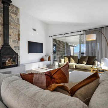 Lounge with sheers beside a wood heater