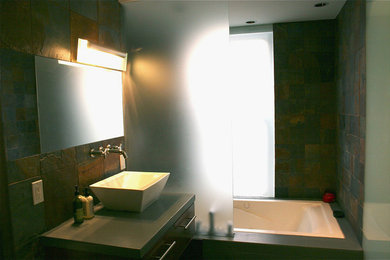Example of a minimalist master bathroom design in Boise with flat-panel cabinets, medium tone wood cabinets, a vessel sink and concrete countertops
