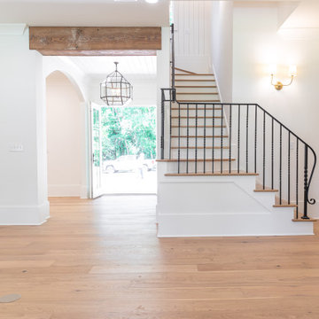 Stairway with Wrought Iron Handrails and Exposed Rustic Beams