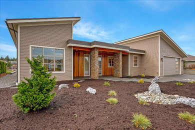 Minimalist beige one-story concrete fiberboard house exterior photo in Seattle with a shed roof and a metal roof