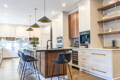 Inspiration for a large contemporary u-shaped eat-in kitchen remodel in Toronto with shaker cabinets, beige cabinets and an island