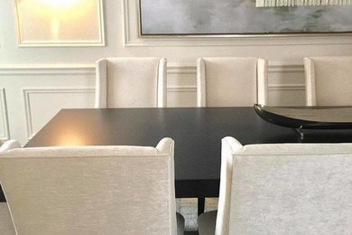 Example of a mid-sized trendy medium tone wood floor and brown floor enclosed dining room design in Toronto with white walls and no fireplace