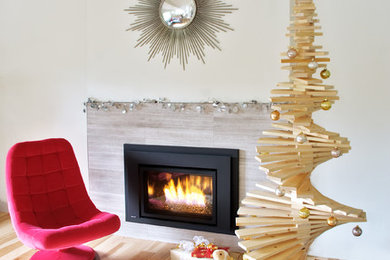 Inspiration for a mid-sized mid-century modern light wood floor and brown floor living room remodel in Vancouver with white walls, a standard fireplace, a stone fireplace and no tv