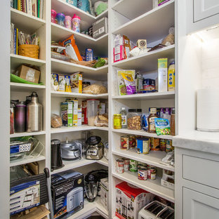 Photo of a large arts and crafts l-shaped kitchen pantry in Salt Lake City with an undermount sink, shaker cabinets, white cabinets, marble benchtops, white splashback, subway tile splashback, stainless steel appliances, brick floors, with island and brown floor.