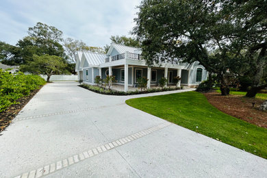 Mid-sized beach style gray one-story concrete fiberboard and board and batten house exterior photo in Other with a metal roof and a gray roof