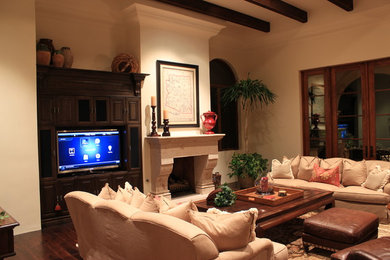 Example of a mid-sized transitional formal and enclosed dark wood floor living room design in Phoenix with beige walls, a standard fireplace, a plaster fireplace and a tv stand