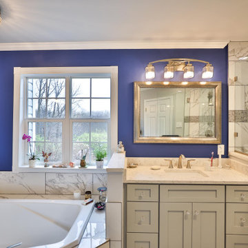 Complete master bathroom remodel in Vienna with marble lined bathtub