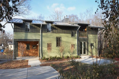 Photo of a large contemporary two-storey multi-coloured house exterior in Nashville with mixed siding, a gable roof and a metal roof.