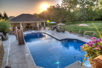 Inspiration for a large transitional backyard stamped concrete and custom-shaped natural water slide remodel in Cedar Rapids