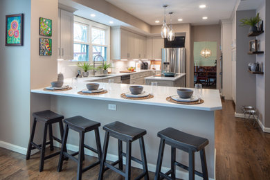 Elegant kitchen photo in Cincinnati with stainless steel appliances and an island