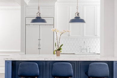 Eat-in kitchen - mid-sized transitional galley medium tone wood floor, brown floor and tray ceiling eat-in kitchen idea in New York with a farmhouse sink, shaker cabinets, white cabinets, marble countertops, white backsplash, marble backsplash, paneled appliances, an island and white countertops