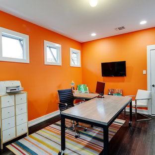 Photo of a medium sized modern study in Austin with orange walls, dark hardwood flooring, no fireplace and a freestanding desk.