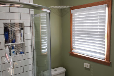 Inspiration for a small contemporary 3/4 laminate floor, brown floor and single-sink bathroom remodel in Columbus with flat-panel cabinets, white cabinets, a two-piece toilet, green walls, an integrated sink and a freestanding vanity