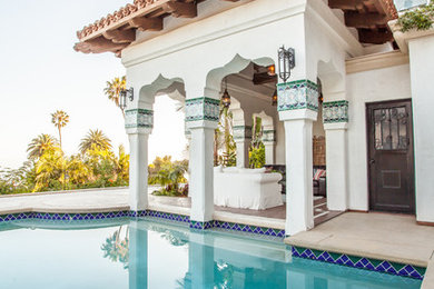Large tuscan backyard stamped concrete and custom-shaped lap hot tub photo in Santa Barbara