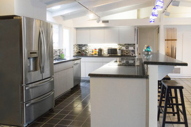 Trendy kitchen photo in Los Angeles with stainless steel appliances, mosaic tile backsplash and an undermount sink