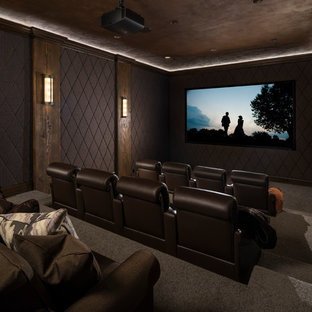 Large rustic enclosed home cinema in Salt Lake City with brown walls, carpet, brown floors and a projector screen.