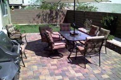 Example of a mid-sized classic backyard brick patio design in Las Vegas with no cover