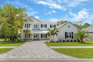 Large country white two-story concrete fiberboard and board and batten exterior home idea in Orlando with a mixed material roof and a gray roof