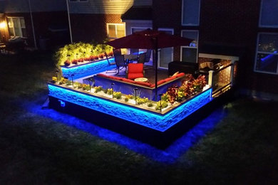 Large trendy backyard deck photo in Other with no cover