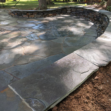 Large Irregular Bluestone Patio, Seating Wall, and Walkways Plus In Laid Design