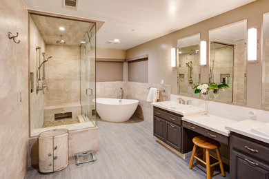 Freestanding bathtub - large modern master beige tile and porcelain tile porcelain tile freestanding bathtub idea in Los Angeles with raised-panel cabinets, dark wood cabinets, gray walls, a drop-in sink and quartzite countertops