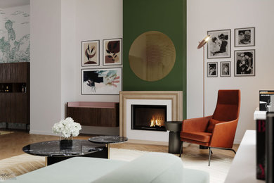 Inredning av ett minimalistiskt allrum, med gröna väggar, ljust trägolv och en öppen vedspis