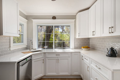 Mid-sized transitional enclosed kitchen photo in Columbus with shaker cabinets, white cabinets, quartz countertops and gray backsplash