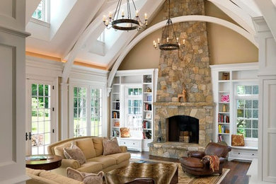 Example of a large classic formal and enclosed dark wood floor living room design in Boston with beige walls, a standard fireplace, a stone fireplace and a media wall