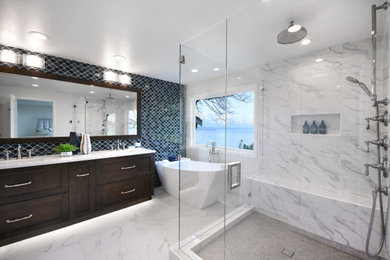 Large transitional master porcelain tile and white tile porcelain tile, white floor and double-sink bathroom photo in Seattle with shaker cabinets, dark wood cabinets, a two-piece toilet, white walls, an undermount sink, quartz countertops, a hinged shower door, white countertops and a built-in vanity