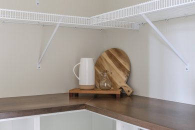 Large country l-shaped open concept kitchen photo in Toronto with shaker cabinets, white cabinets, wood countertops, an island and brown countertops