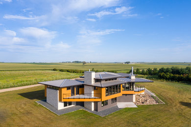 Inspiration for a large contemporary multicolored two-story mixed siding house exterior remodel in Other with a hip roof and a metal roof