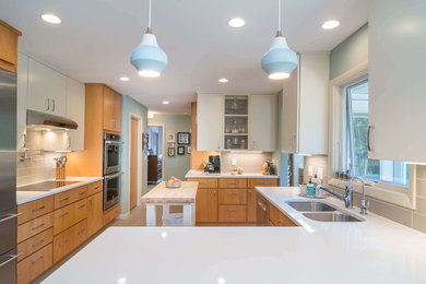 Eat-in kitchen - mid-sized transitional l-shaped ceramic tile and beige floor eat-in kitchen idea in Other with an undermount sink, flat-panel cabinets, white cabinets, granite countertops, beige backsplash, ceramic backsplash, stainless steel appliances and a peninsula