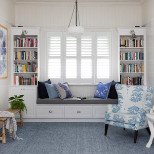 Photo of a mid-sized transitional open concept family room in Brisbane with a library, white walls, no tv, carpet, no fireplace and blue floor.