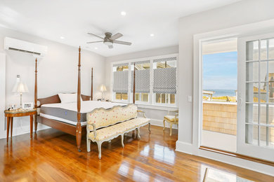 Inspiration for a large coastal master dark wood floor and brown floor bedroom remodel in New York with gray walls and no fireplace