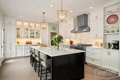 Enclosed kitchen - large traditional u-shaped linoleum floor and brown floor enclosed kitchen idea in Seattle with an undermount sink, recessed-panel cabinets, white cabinets, quartz countertops, beige backsplash, ceramic backsplash, stainless steel appliances, an island and white countertops