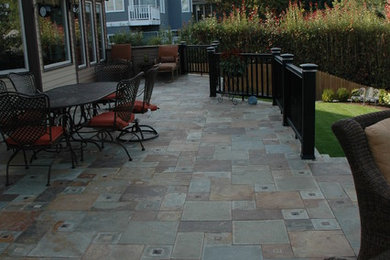Patio - large eclectic backyard tile patio idea in Portland with a fire pit