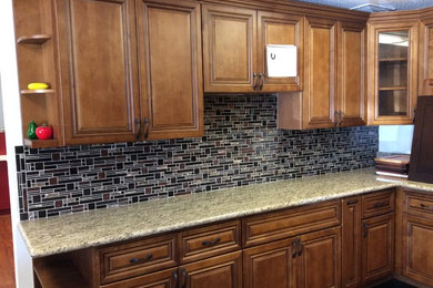 Inspiration for a mid-sized transitional kitchen remodel in Los Angeles with granite countertops, multicolored backsplash, glass tile backsplash, no island, raised-panel cabinets and medium tone wood cabinets