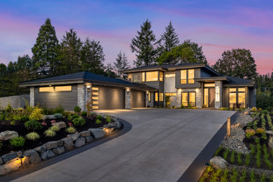 Inspiration for a huge contemporary gray two-story mixed siding house exterior remodel in Portland with a hip roof, a shingle roof and a black roof