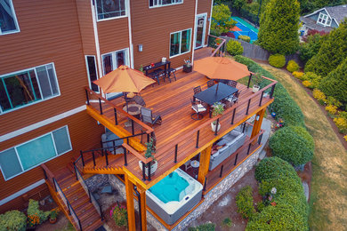Design ideas for a large modern backyard deck in Seattle with no cover.