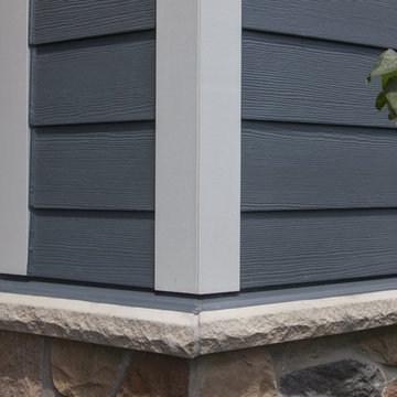 Shiny new Andersen Windows, Evening Blue James Hardie siding & stone accents