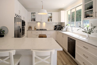 Inspiration for a traditional kitchen in Sunshine Coast with shaker cabinets and white cabinets.