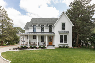 Mid-sized country two-story wood and clapboard exterior home idea with a metal roof and a gray roof