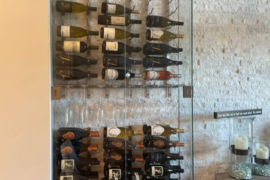 Example of a wine cellar design in Other with display racks