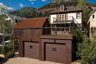 Inspiration for a large industrial attached two-car garage workshop remodel in Denver