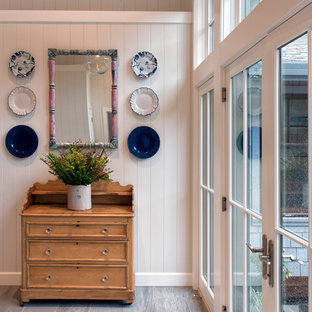 他の地域の小さい両開きドアおしゃれな玄関ラウンジ (白い壁、ラミネートの床、白いドア、グレーの床) の写真