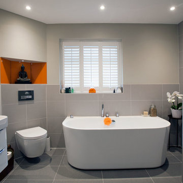 Modern, minimal family bathroom with orange accents - Burgess Hill