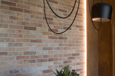 Photo of a medium sized industrial open plan dining room in Venice with light hardwood flooring and brick walls.
