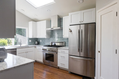 This is an example of a mid-sized transitional galley kitchen pantry in Seattle with an undermount sink, shaker cabinets, white cabinets, quartz benchtops, blue splashback, glass tile splashback, stainless steel appliances, medium hardwood floors, no island, multi-coloured floor and multi-coloured benchtop.