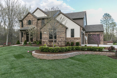 Mid-sized transitional brown two-story brick gable roof photo in Detroit